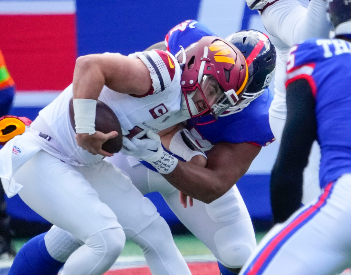 New York Giants defensive tackle Dexter Lawrence II (97) sacks Washington Commanders quarterback Sam Howell (14) in the first half at MetLife Stadium.